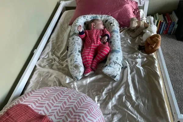 A baby transitioning to sleep in his Montessori floor bed