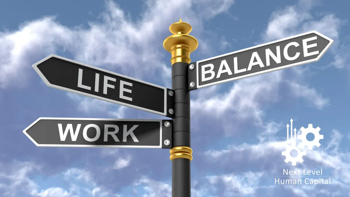 Signpost showing directions for Life, Work, and Balance against a blue sky, representing the work-life balance concept