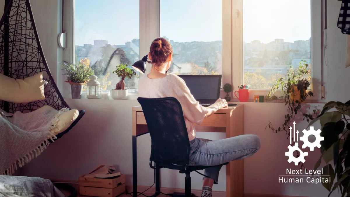 Professional working from a home workspace, illustrating modern workforce mobility and flexible work environments