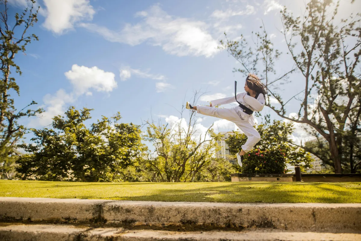 Woman Martial Artist Jump Kicking