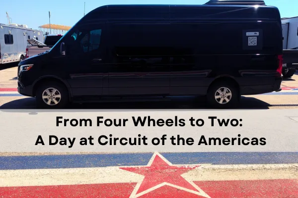 Black RCLLC Transportation van parked at Circuit of the Americas racetrack in Austin, with RVs and trailers visible in the background. The blog post title 'From Four Wheels to Two: A Day at Circuit of the Americas' is overlaid on the image, with a red star logo visible on the pavement