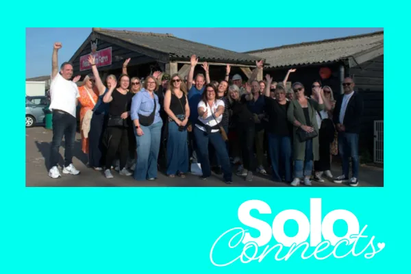 Image shows Solo Connects community members having fun outside a large barn.