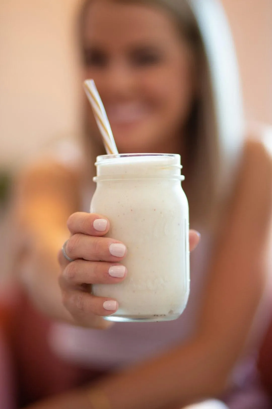 woman enjoying a protein smoothie while on GLP-1 medication, representing healthy eating and balanced nutrition with a smaller appetite.