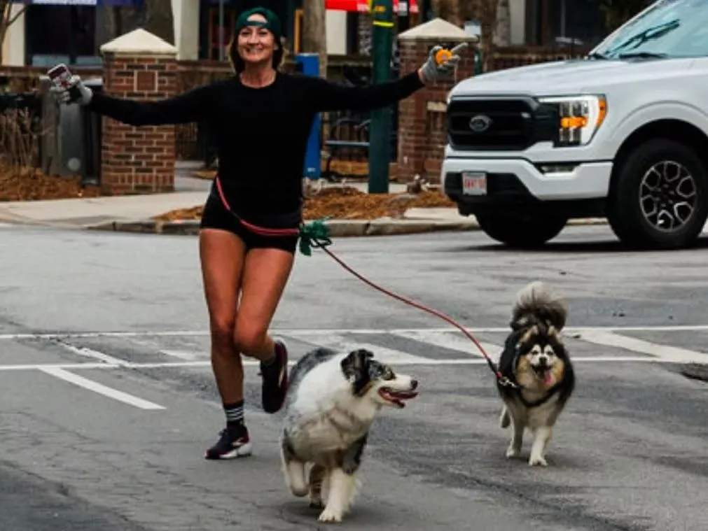 Kristen Ripmaster running with her dogs after hurricane Helen
