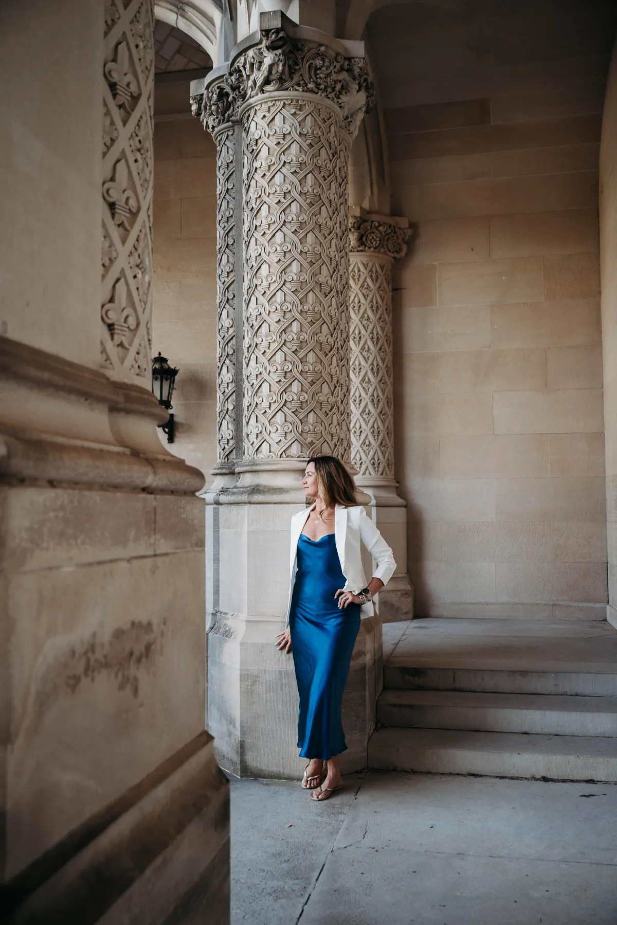 Kristen Ripmaster standing confidently in a blue dress and white blazer, representing a bold career shift and stepping into personal power