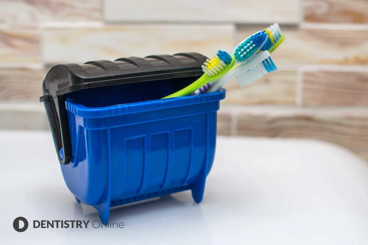 small bin with toothbrushes in