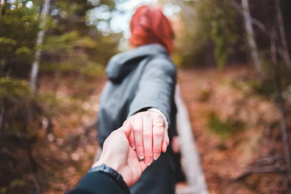 a woman leads someone by the hand