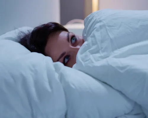 fearful woman in bed