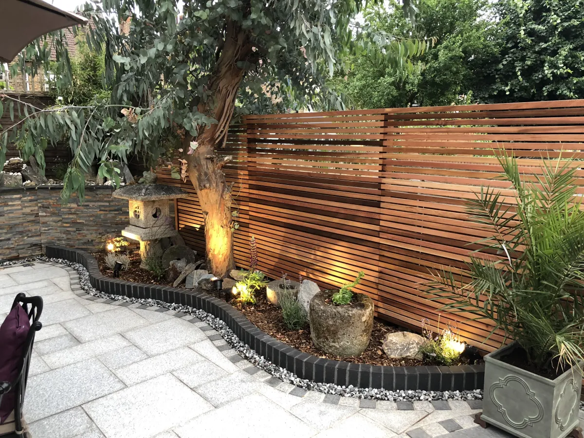 Tranquil garden design incorporating sedar wood and raised bedding borders using brick-work 