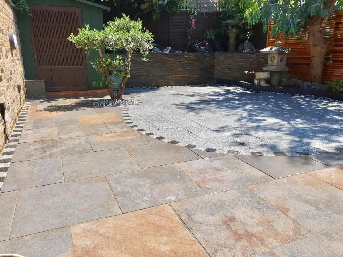 porcelain and granite detailed patio installed in Ealing. This patio is one of our full garden designs. The patio creates a warm and welcoming environment