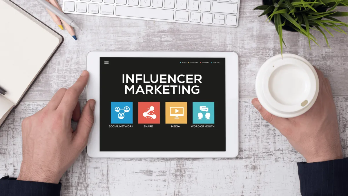 Desek with papers with the words influencer marketing