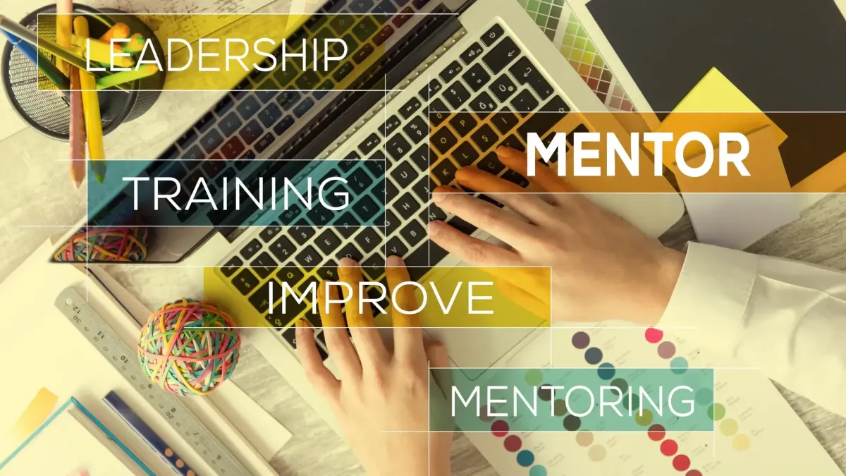Hands on a keyboard with bloks of word text that says leadership. mentoring, Training, Improve