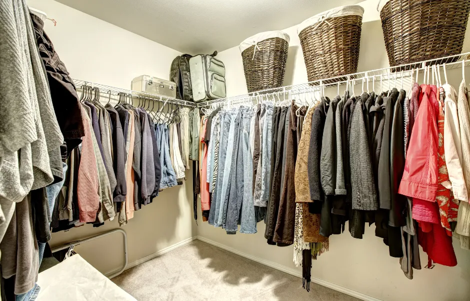 A selection of women's clothes inside a closet