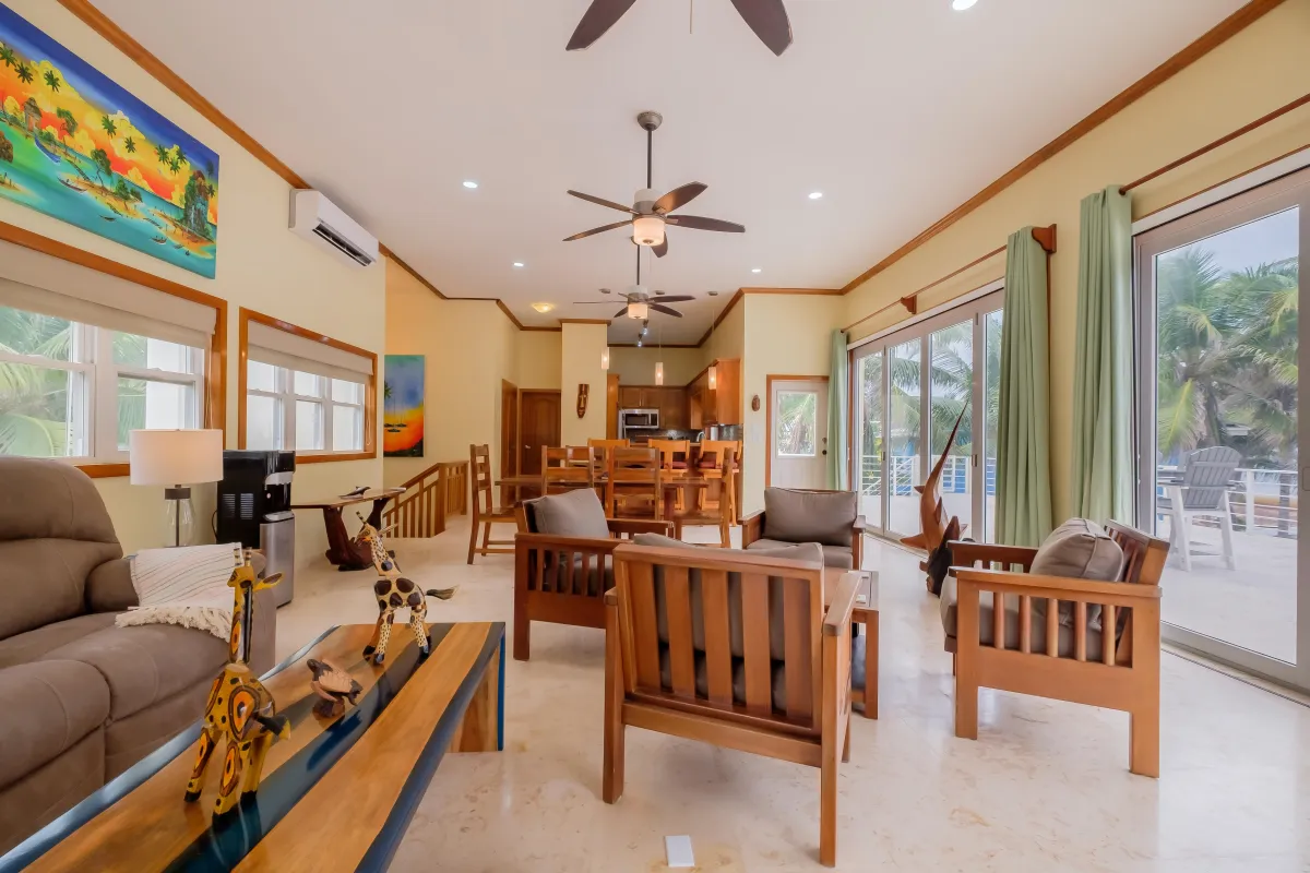 Gaze at the beach from inside the living room of this vacation rental in Ambergris Caye Belize