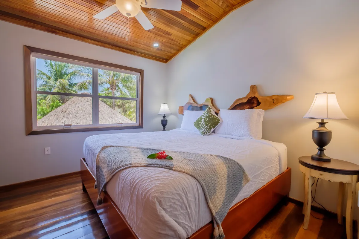 Vacation rentalin Ambergris Caye has Bedroom with ceiling fan and AC