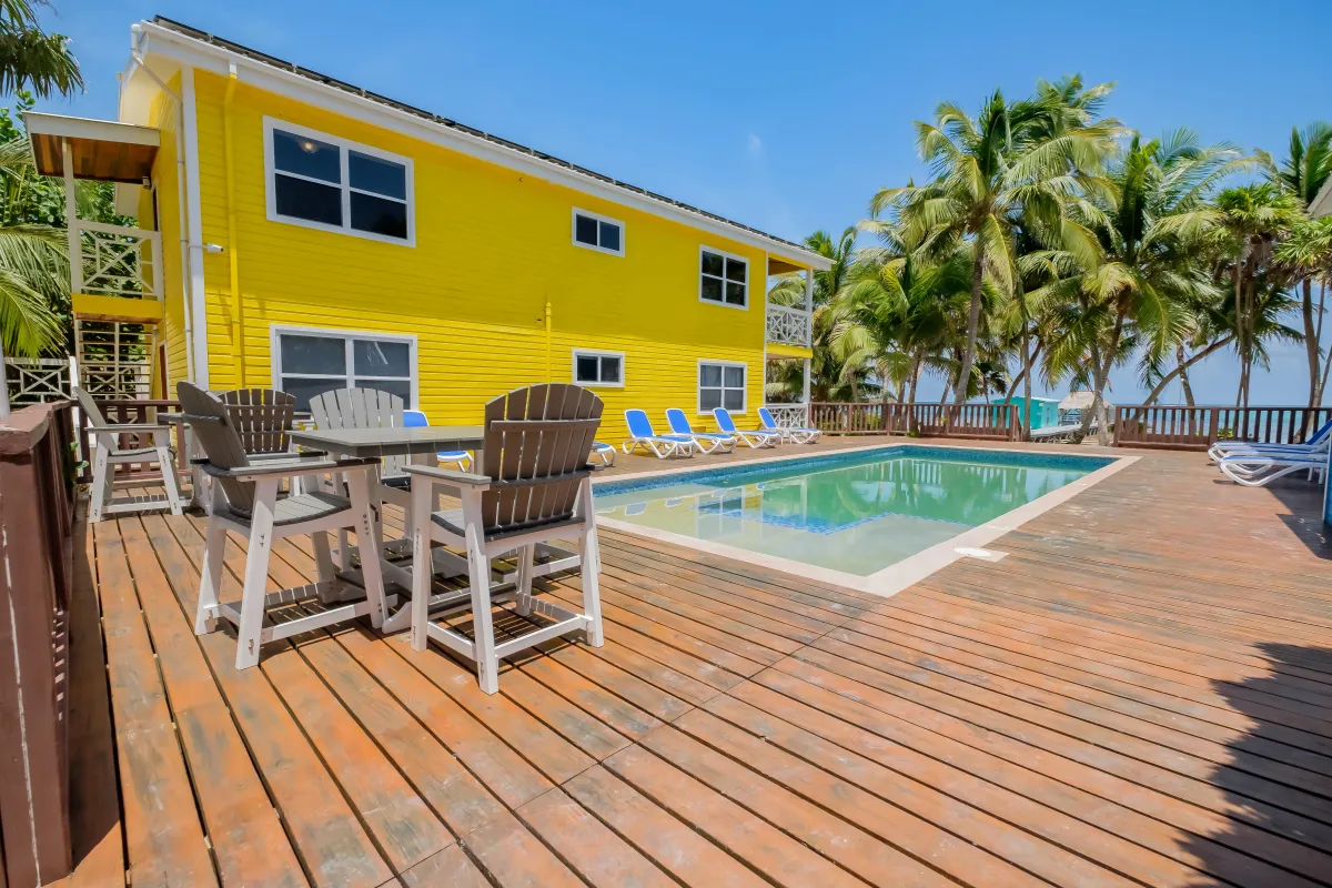 Pool area with pool loungers and table and chairs