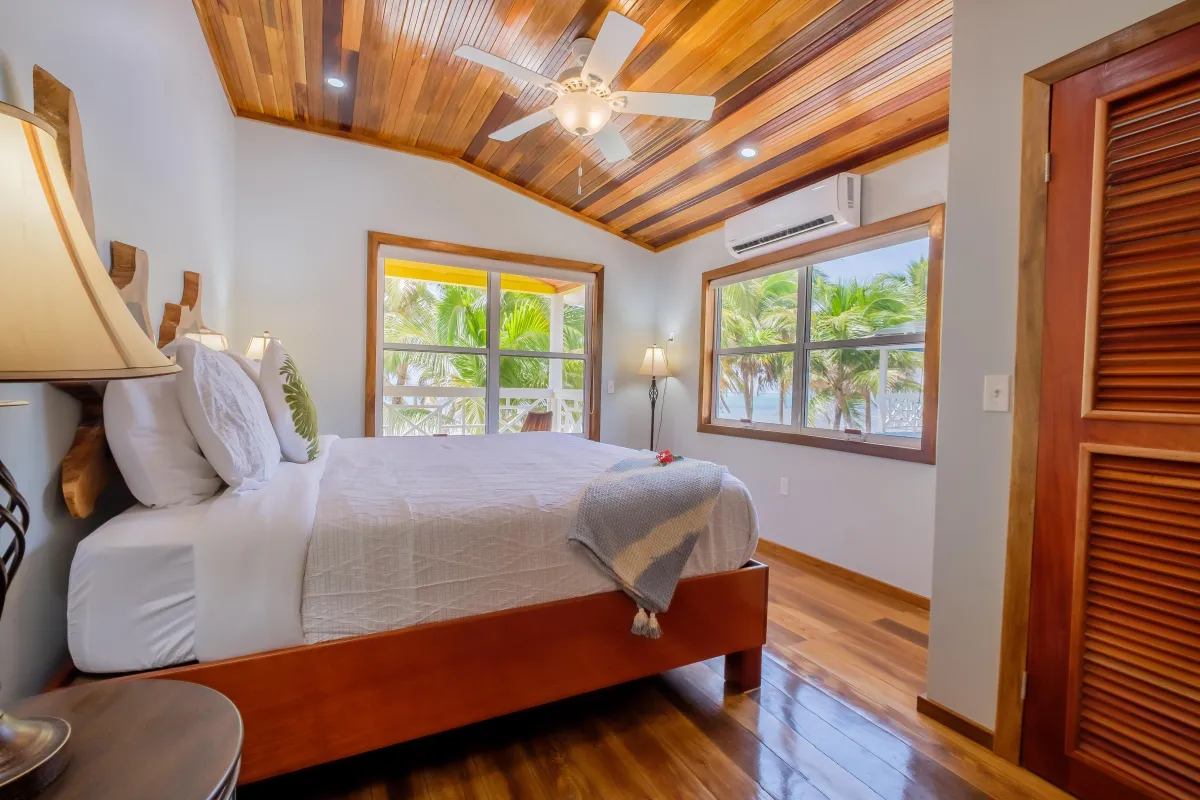 Vacation Rental in Ambergris Caye with bedrom with ceiling fan and AC and views of the beach