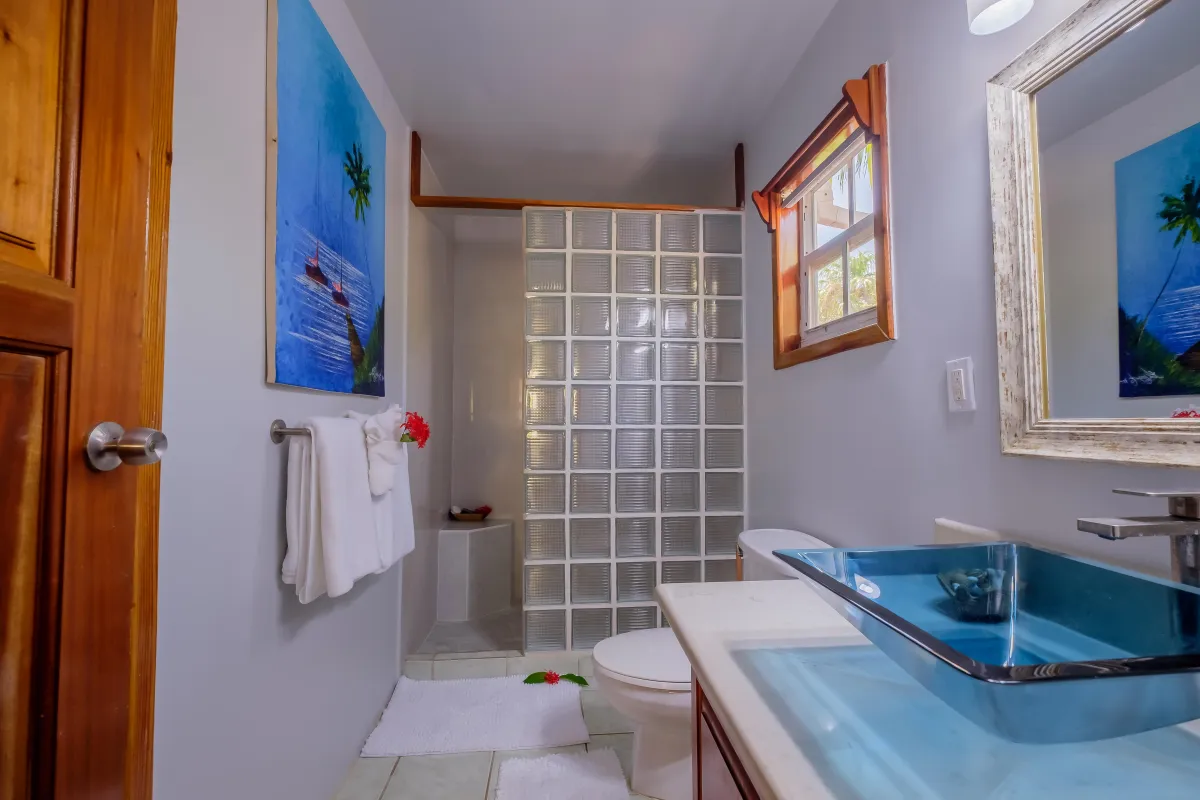 full bathroom with dual sinks and walkin shower