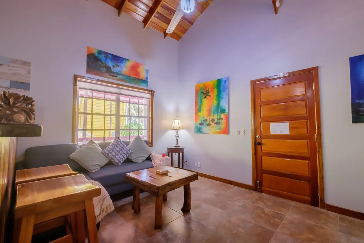 Living area with couch, and coffee table in Ambergris Caye beach villa