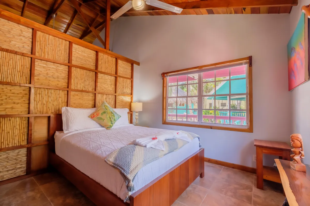 Bedroom with ceiling fan and AC