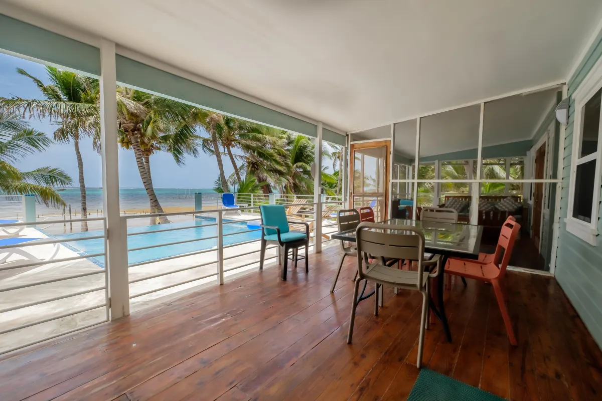 Vacation Rental in Ambergris Caye Belize with Open covered patio to pool with table and chairs