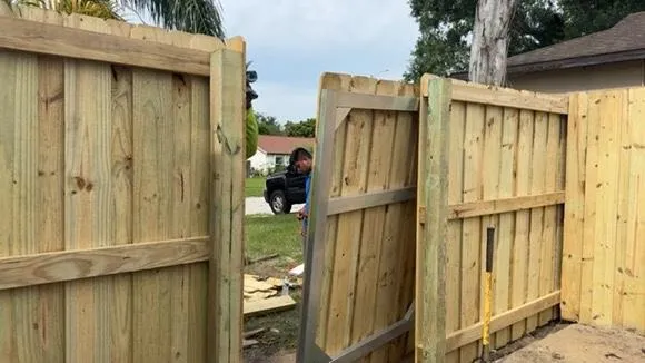 Wood fence damage after storm in Tampa Bay home