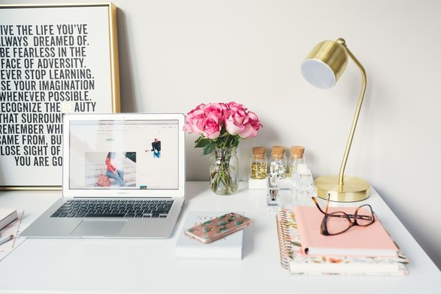 Laptop and desk setup for planning an online course that sells