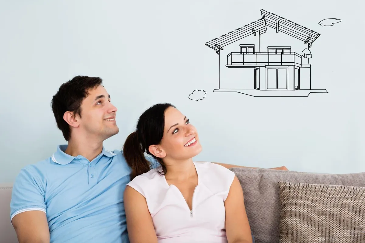 Couple on couch staring at visualized dream property 