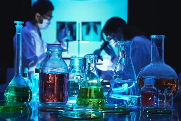 Focused lab technician conducting experiments, surrounded by various lab equipment meticulously managed.