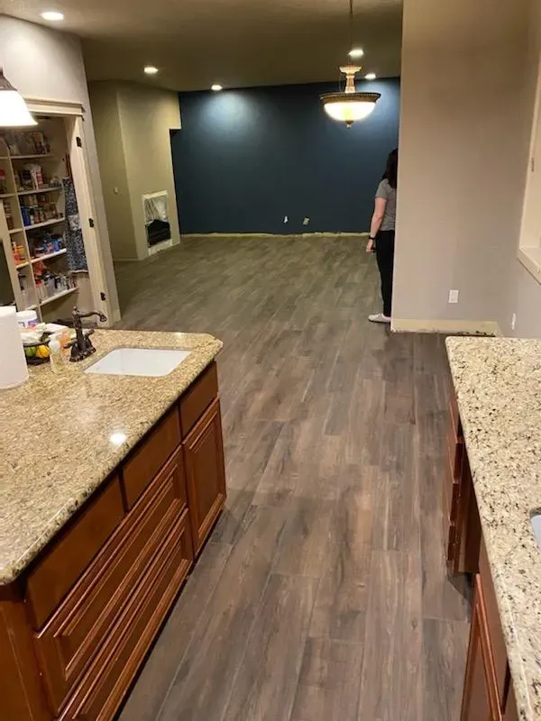 Luxury vinyl plank flooring installation in a residential kitchen and living area by Parker Built Construction in Oregon