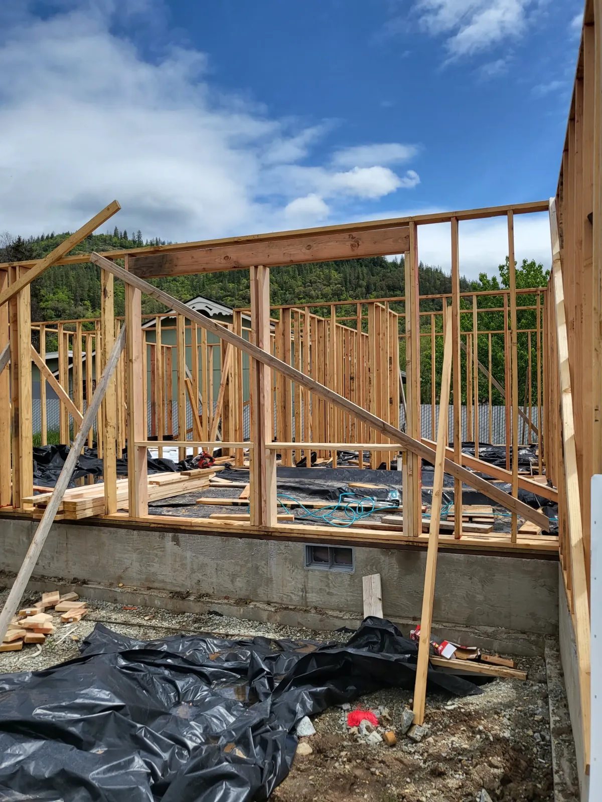 Wood frame wall setup on concrete foundation during home construction in Oregon by Parker Built