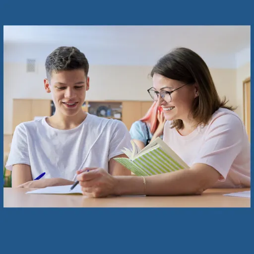 Teacher helping a GCSE student with English work – AQA English Language GCSE tutoring support.