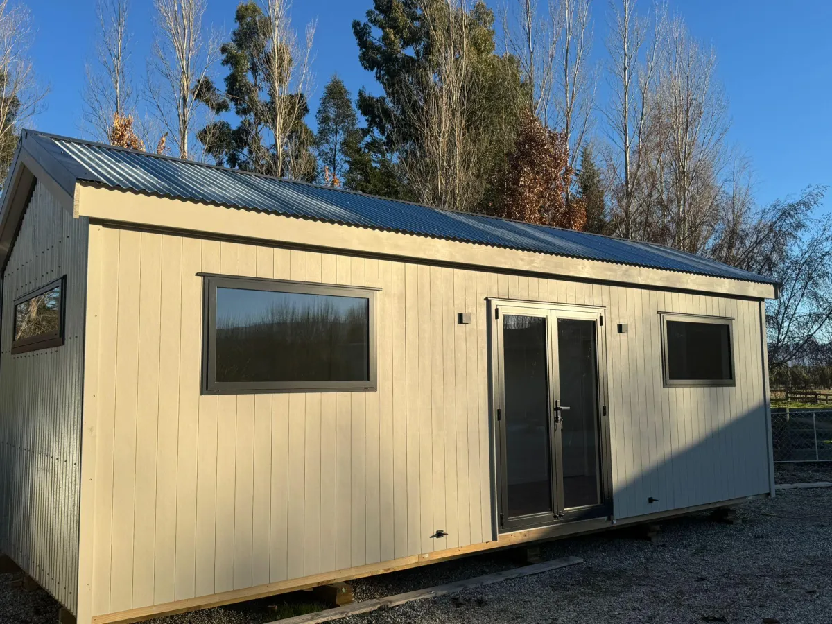 Exterior side view of tiny home with steel and weatherboard finish in Alexandra, Central Otago.