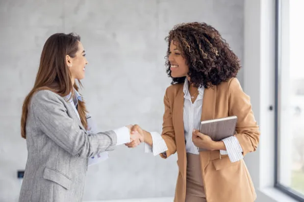 Simplify Your Tech women shaking hands