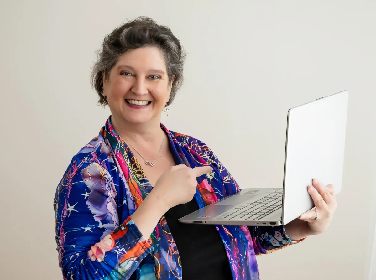 Simplify Your Tech woman pointing to laptop