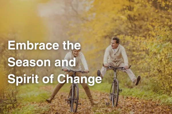 older man and woman riding bike through fall foliage, text: embrace the season of change