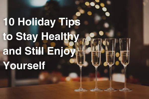 champagne in front of a Christmas tree text: 10 Holiday Tips to Stay Healthy and Still Enjoy Yourself