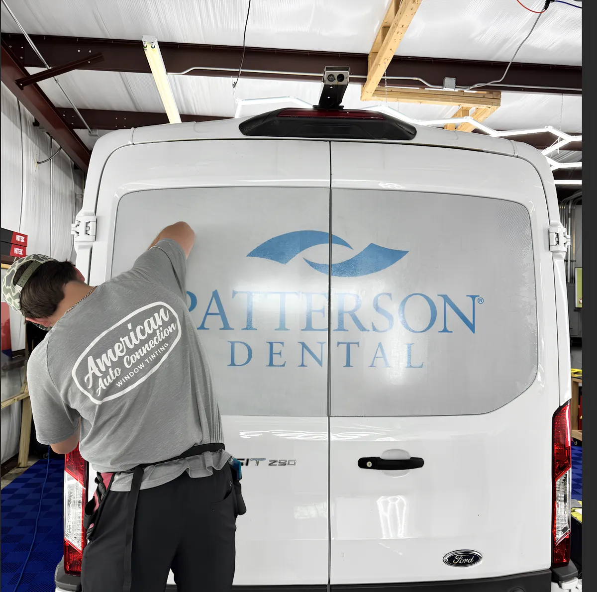 White van with company logo applied via vinyl wrap in Clayton NC.