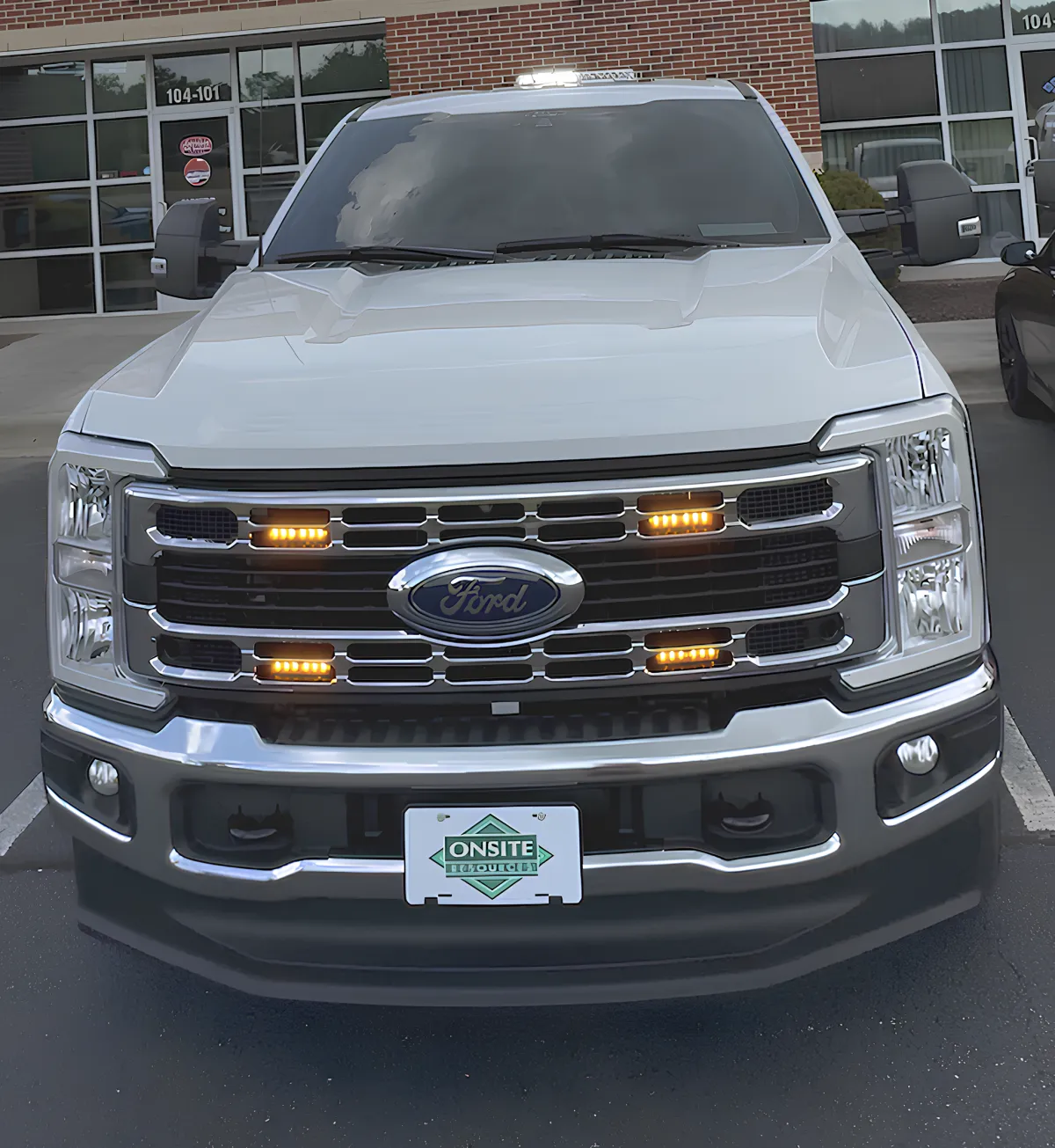 Pickup truck with strobe light bar installed for safety.