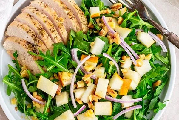 Pear arugula salad with chicken, nuts, and tangy dressing