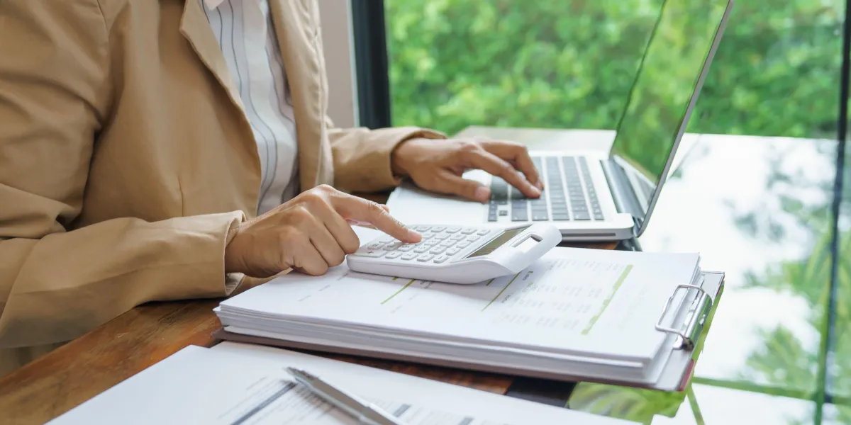 Lady at a desk with calculator