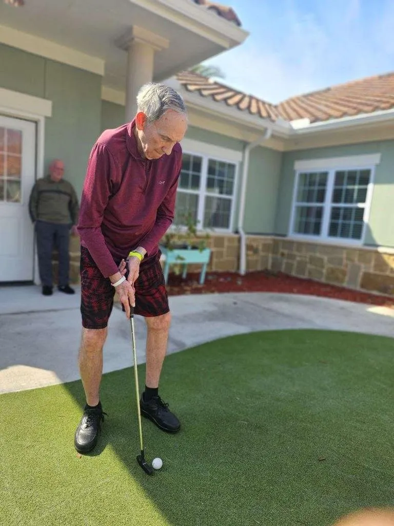 Gulf Coast Memory Care Resident Golfing