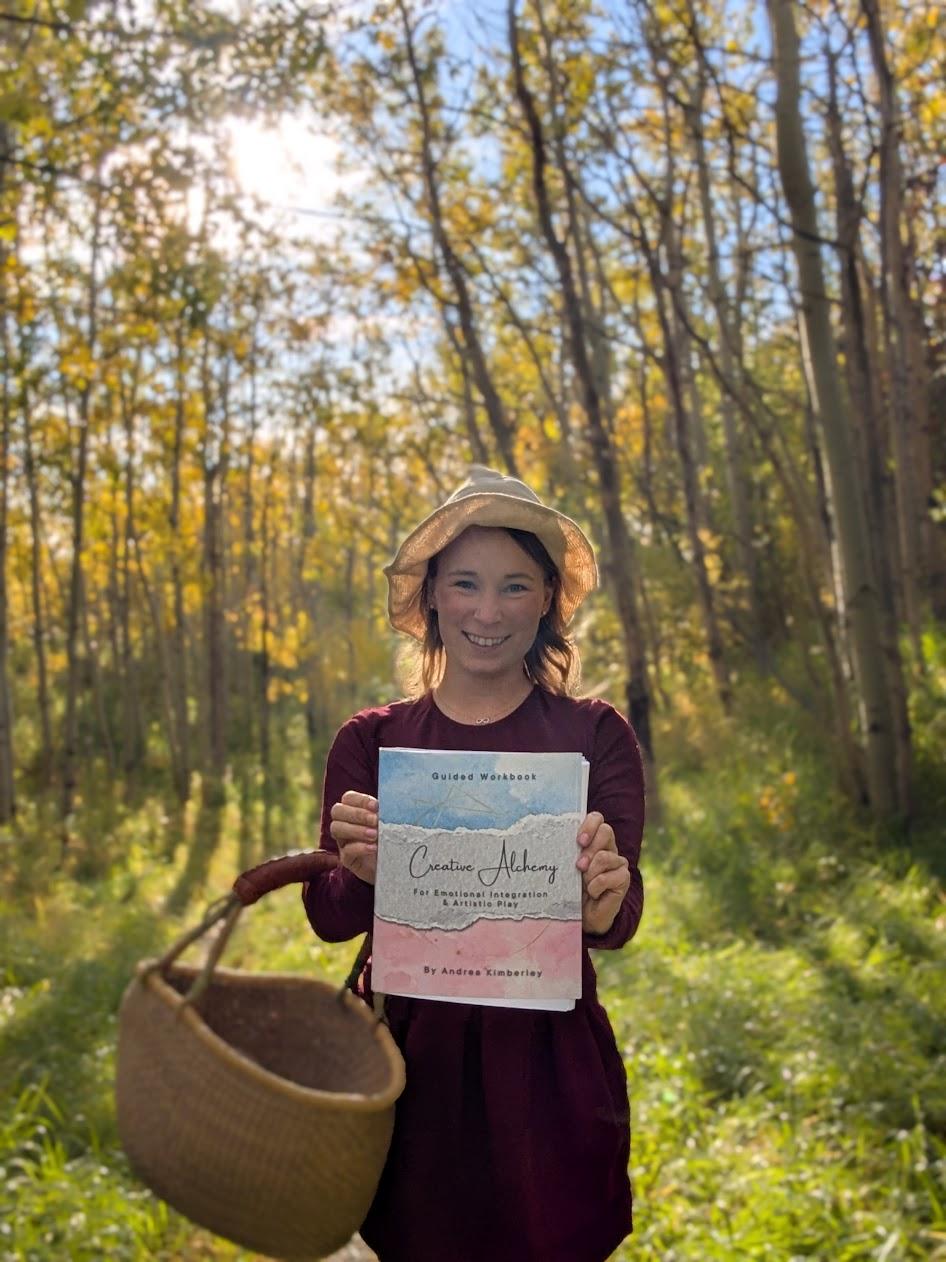 Hands making simple lines and color marks in an art journal, representing gentle art journaling for beginners.