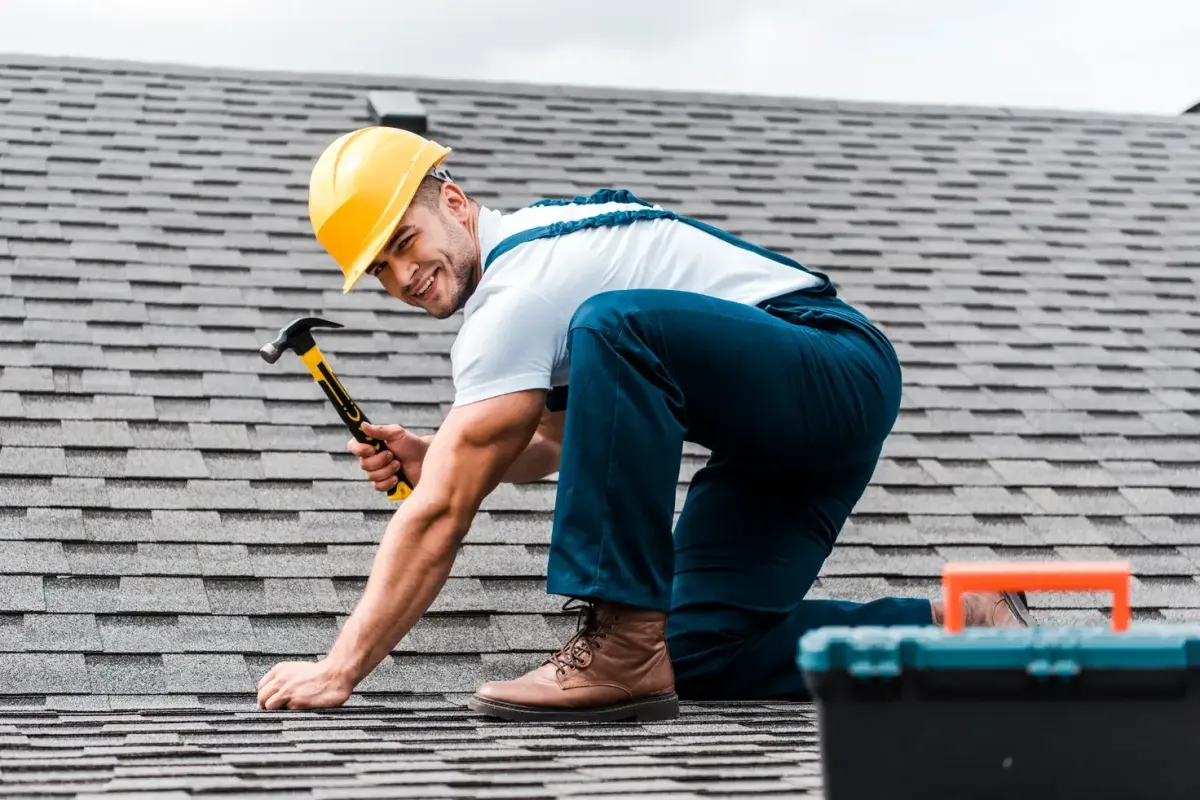 Happy roofer working on project that generates positive roofing testimonials and reviews