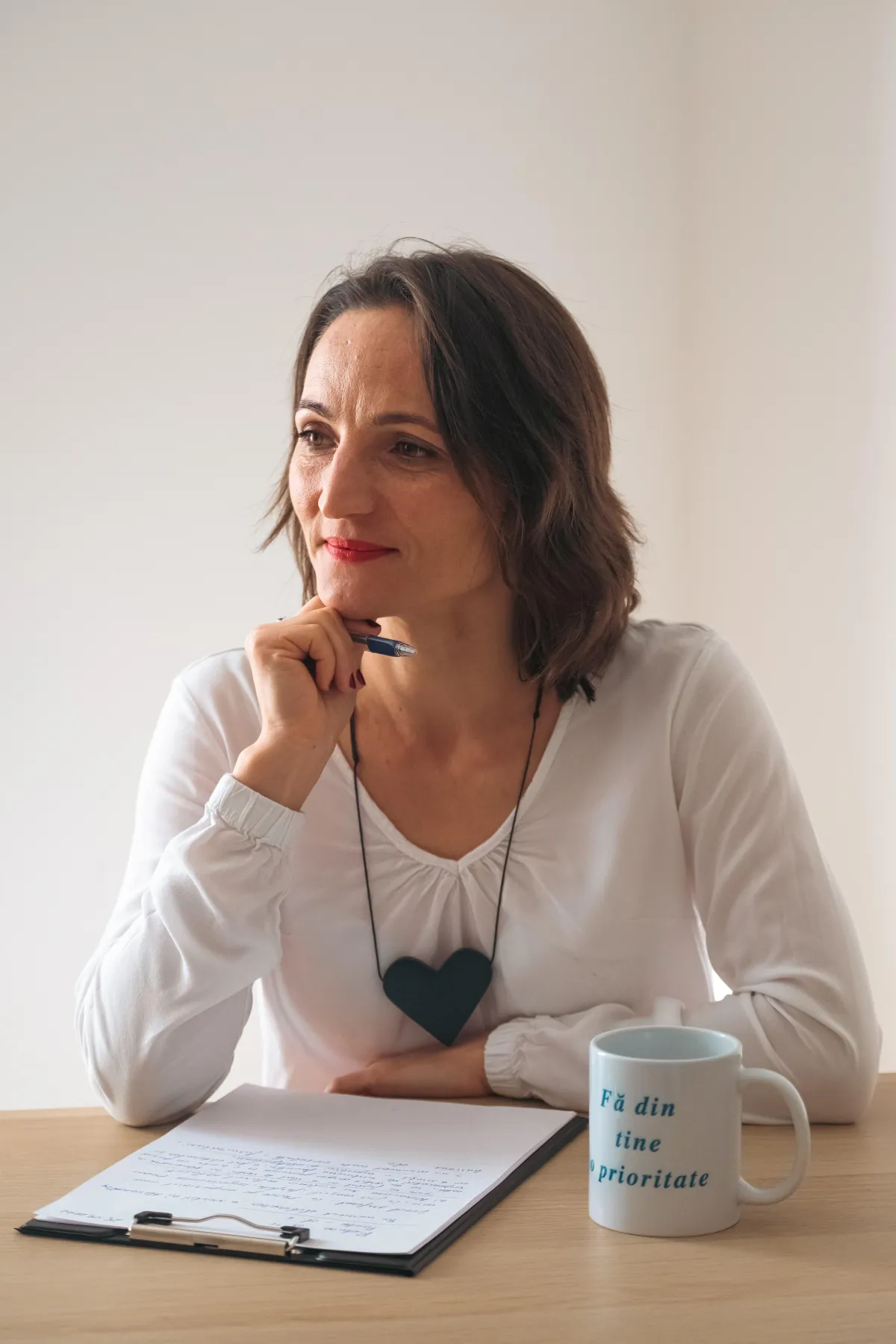 woman sitting at table thinking