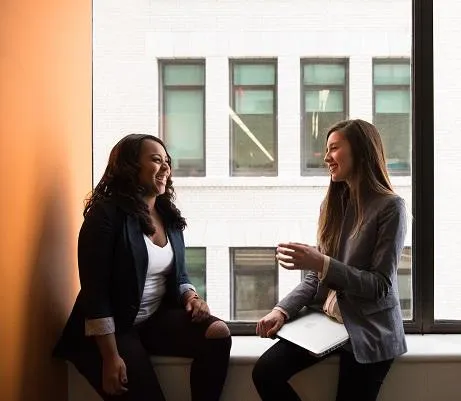 Two women talking in an intimate setting