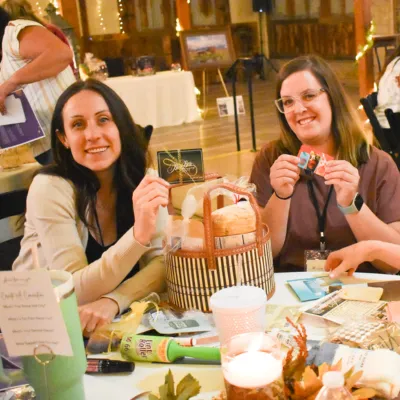 Women making graduation baskets for single moms.
