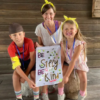 Family shares their flag during a camping retreat.