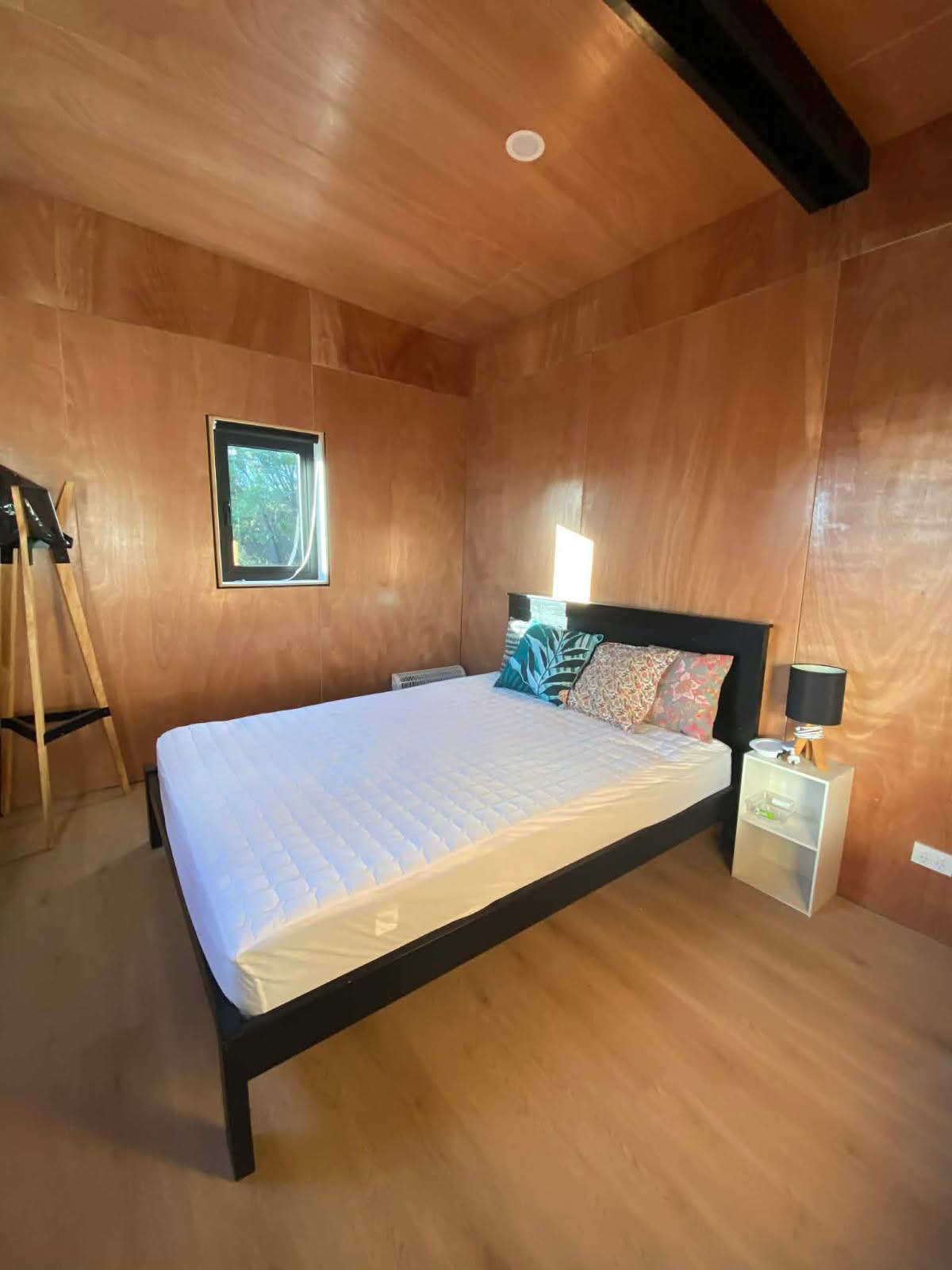 Freshly painted bedroom interior with timber walls Kaitaia Far North NZ