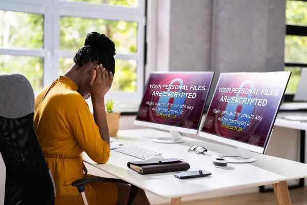 business women with head in hands after a ransomware attack